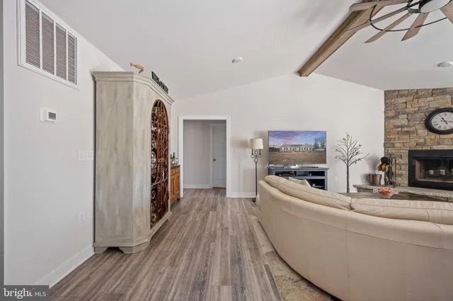 a kitchen with stainless steel appliances granite countertop a sink and wooden floor