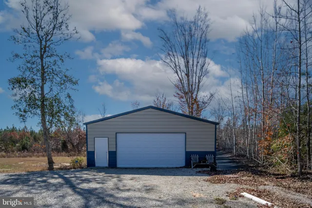 a view of a field with trees in the background