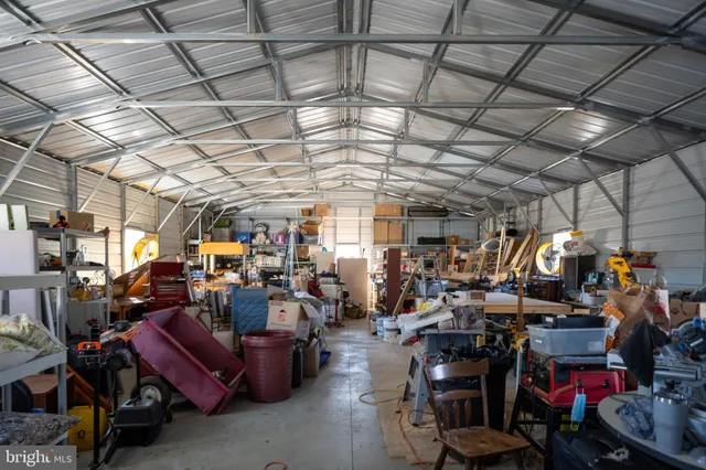 a aerial view of a house next to a yard with mountain