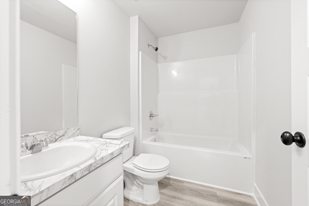 522 Oil Mill Road, Unit 10 Martin, GA 30557 - Photo 20 of 30 a bathroom with a granite countertop sink toilet and shower
