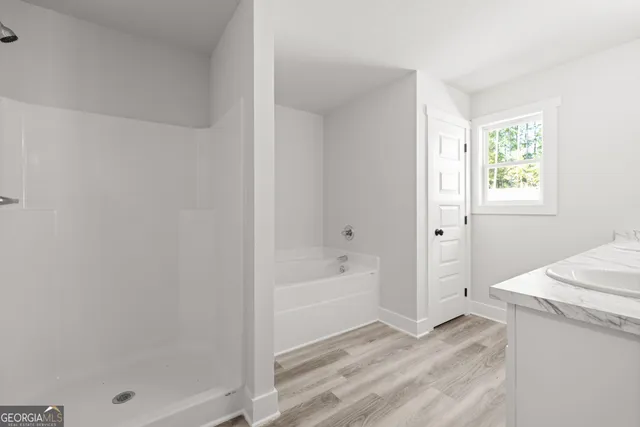 a bathroom with a sink a mirror and a window