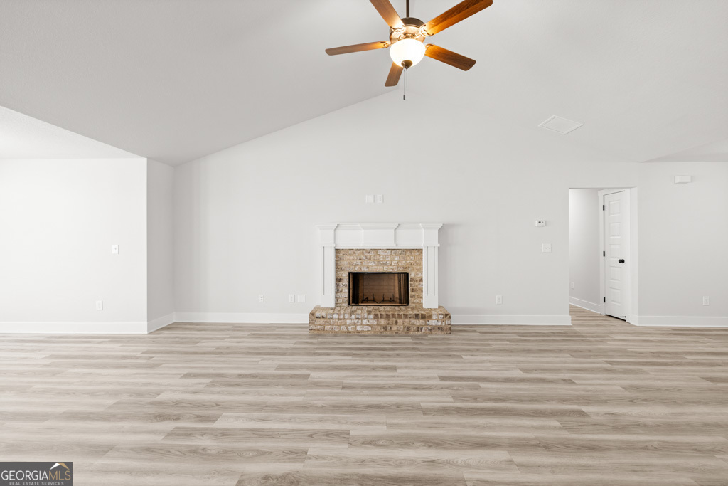 522 Oil Mill Road, Unit 10 Martin, GA 30557 - Photo 4 of 30 a view of a livingroom with a fireplace a ceiling fan and wooden floor