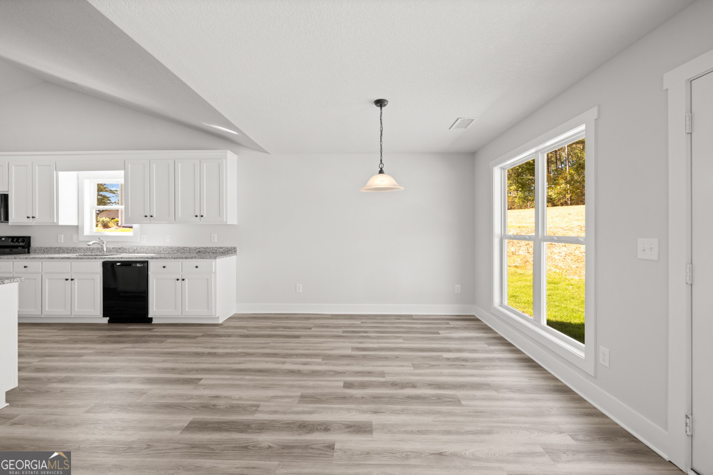 522 Oil Mill Road, Unit 10 Martin, GA 30557 - Photo 7 of 30 a view of a kitchen center island with wooden floor and staircase