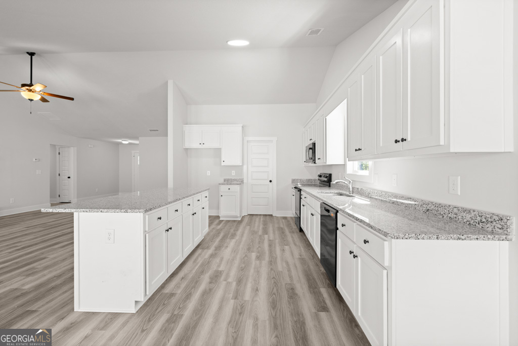 522 Oil Mill Road, Unit 10 Martin, GA 30557 - Photo 9 of 30 a kitchen with granite countertop a sink stove and cabinets