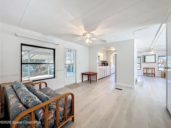 a living room with furniture and two window