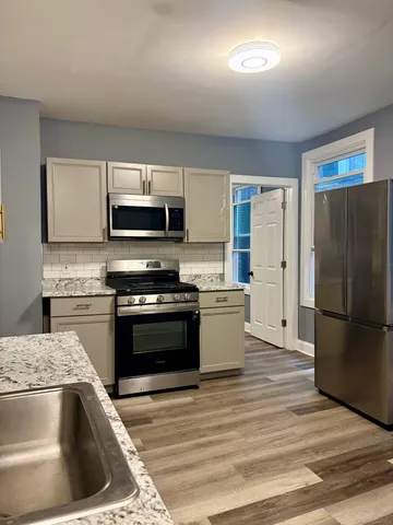 a kitchen with a refrigerator stove and microwave