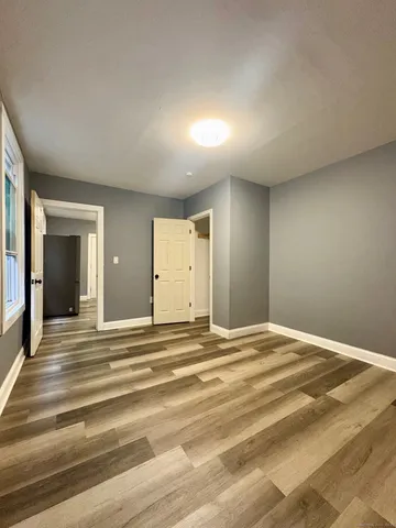 a view of a livingroom with wooden floor and closet