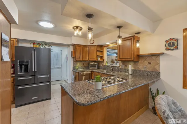 a kitchen with a stove a sink dishwasher and cabinets with wooden floor