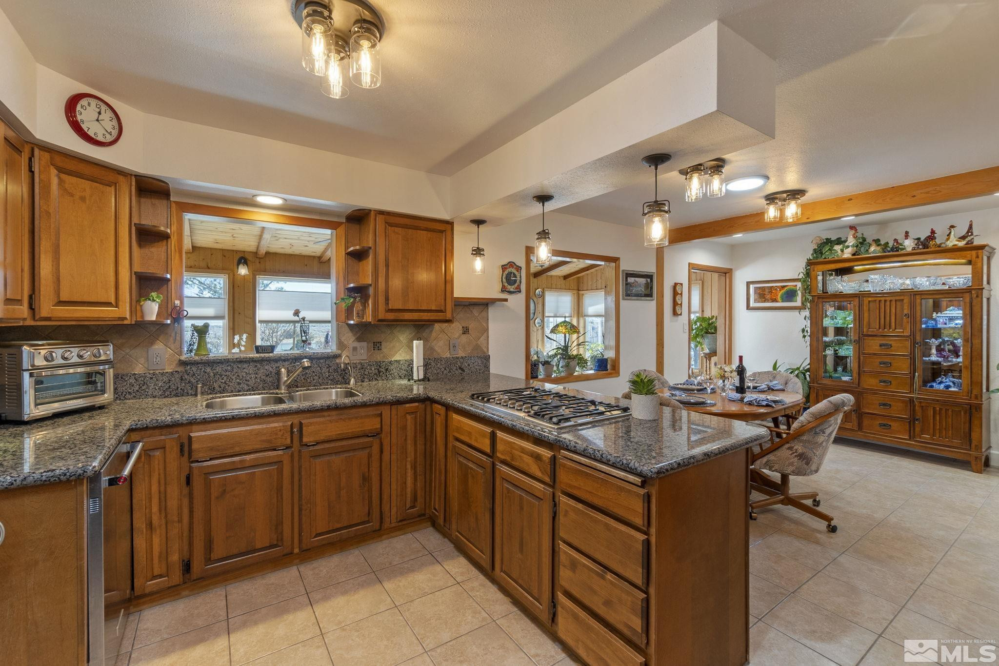 525 Main Street Gerlach, NV 89412 - Photo 13 of 40 a kitchen with a stove a sink dishwasher and cabinets with wooden floor