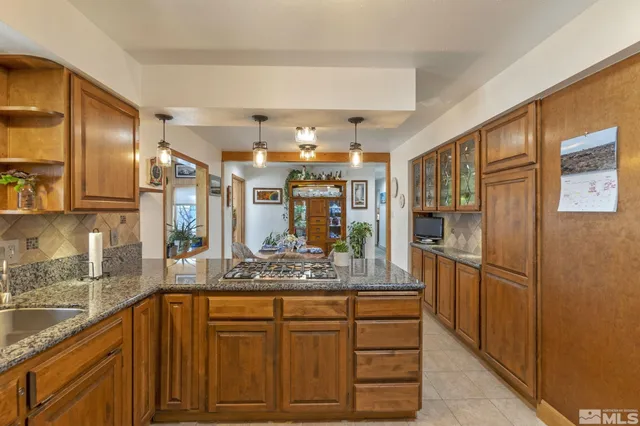 a kitchen with stainless steel appliances granite countertop a refrigerator stove and sink