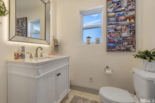 a bathroom with a shower sink and mirror