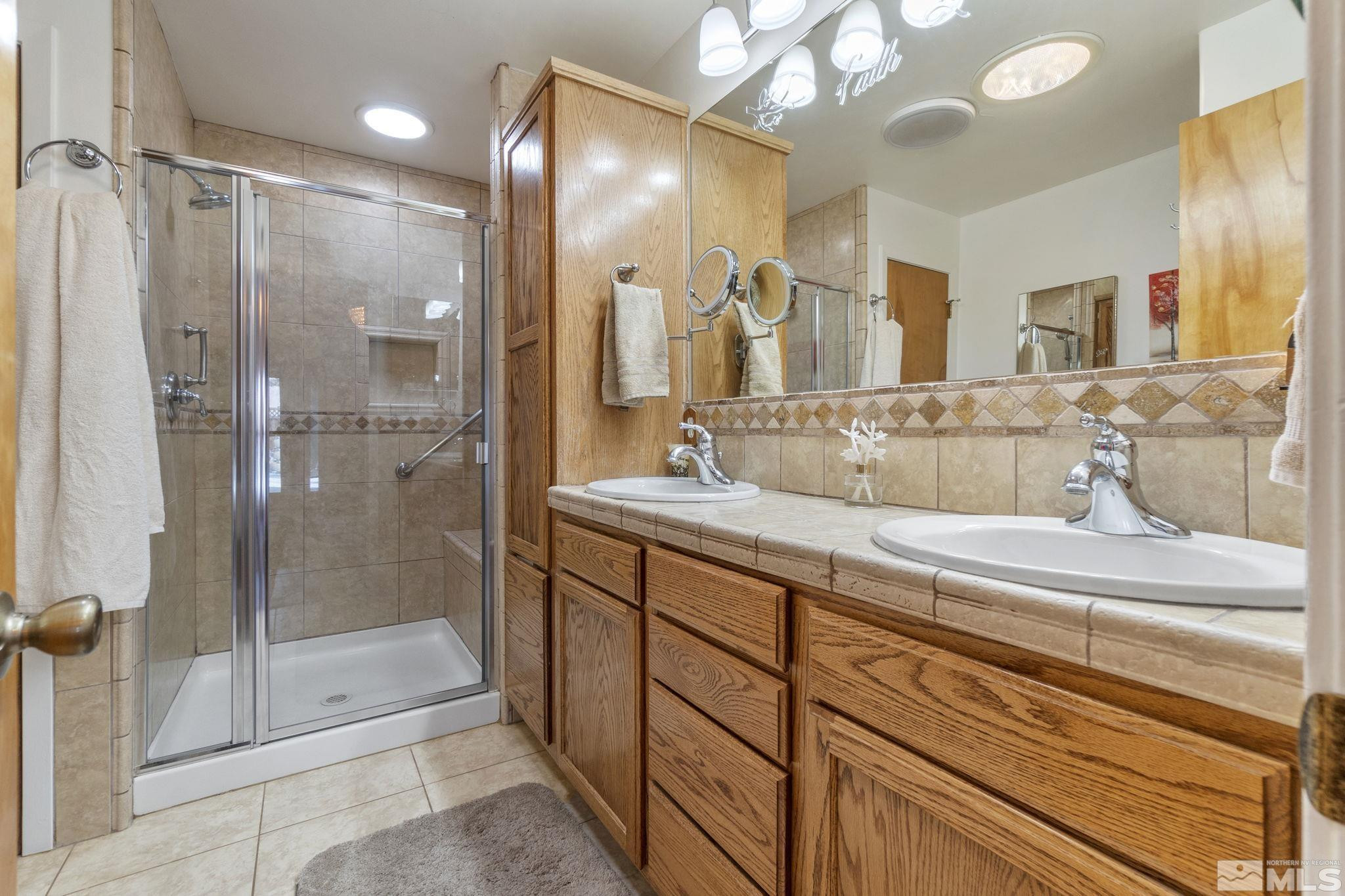 525 Main Street Gerlach, NV 89412 - Photo 29 of 40 a bathroom with a shower sink and mirror