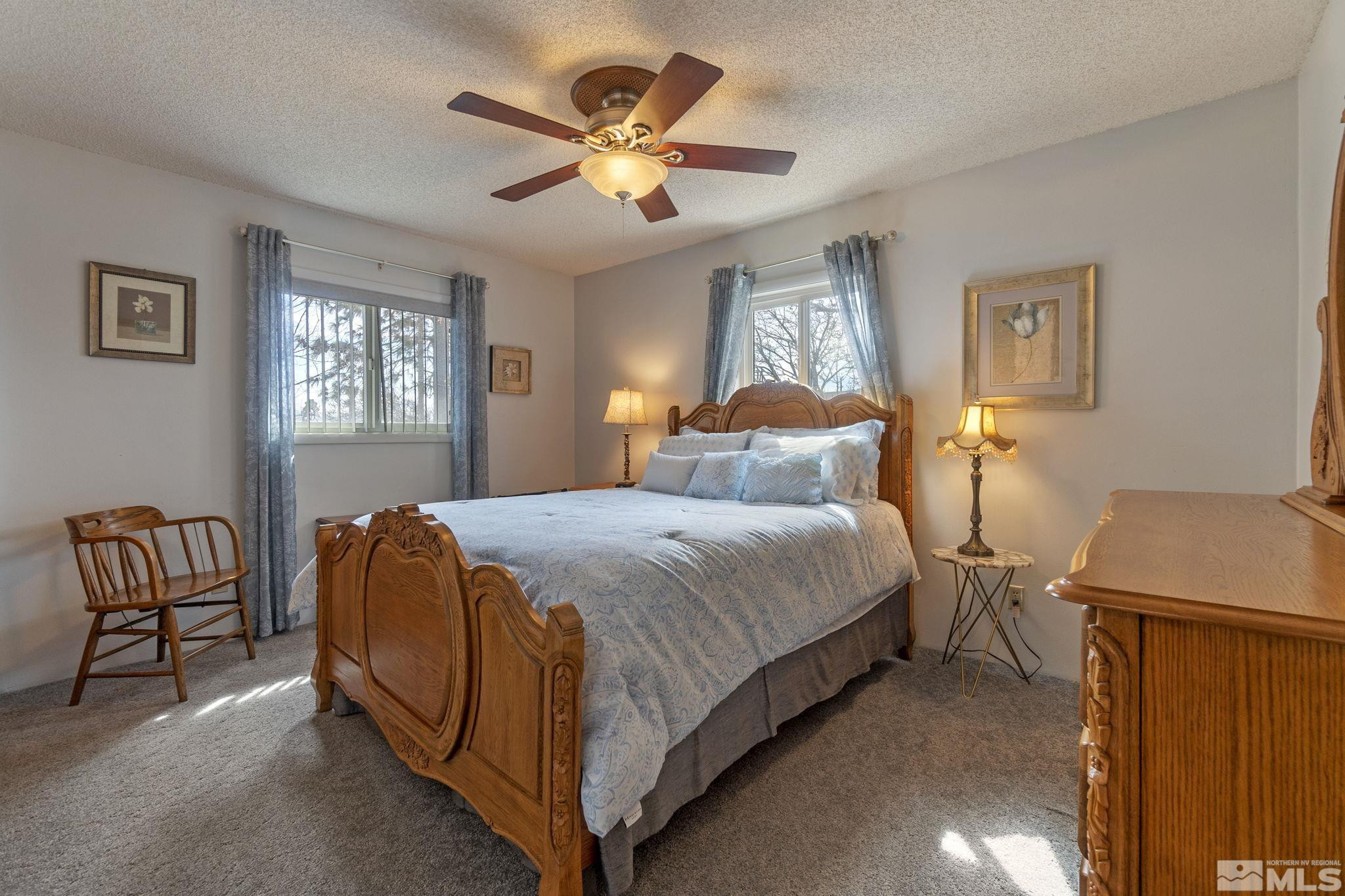 525 Main Street Gerlach, NV 89412 - Photo 32 of 40 a bedroom with a bed and a chandelier