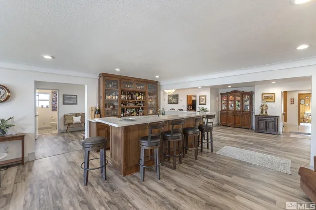a living room with furniture a desk and kitchen view