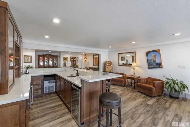 a living room with furniture appliances and kitchen view