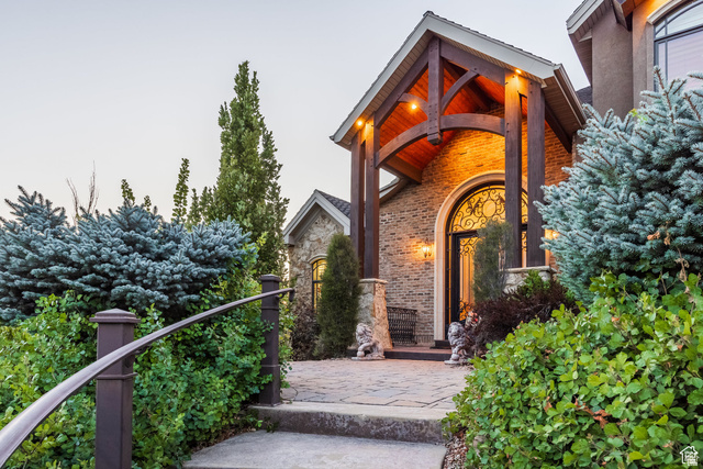 694 West Cephus Road Draper, UT 84020 - Photo 8 of 148 Arched entry with decorative ironwork door, complemented by a wood-beamed portico and brick facade