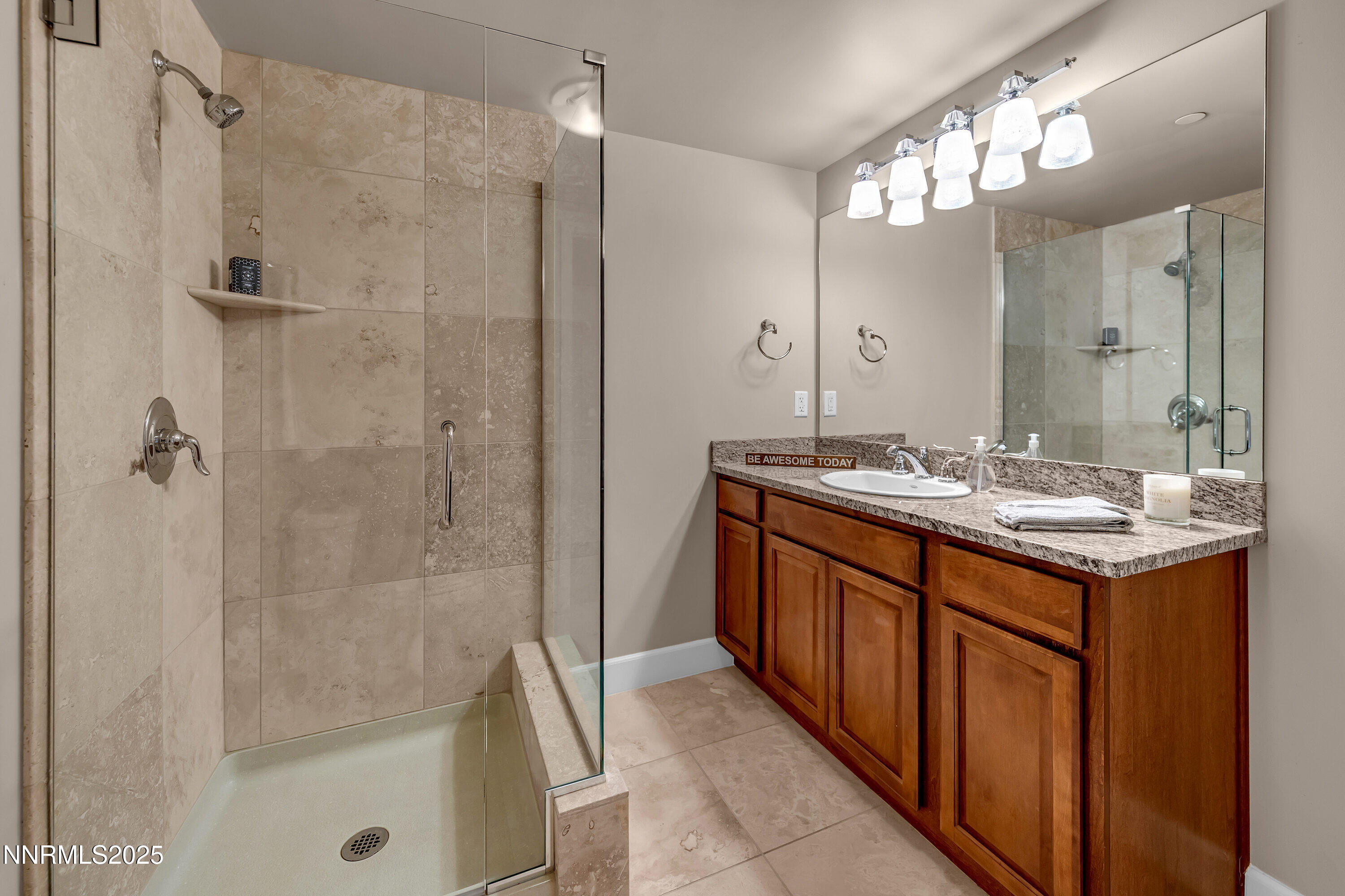 50 North Sierra Street, Unit 910 Reno, NV 89501 - Photo 11 of 20 a bathroom with a double vanity sink a large mirror and shower