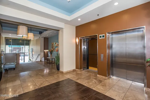 a view of a hallway with dining area and glass door