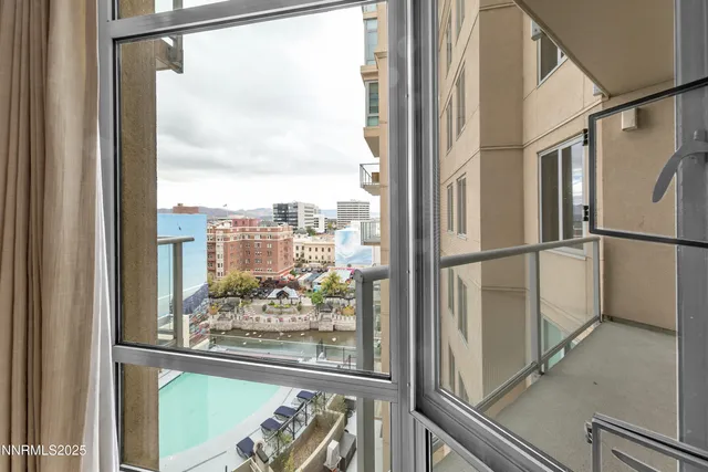 a view of a glass door with a balcony from a window