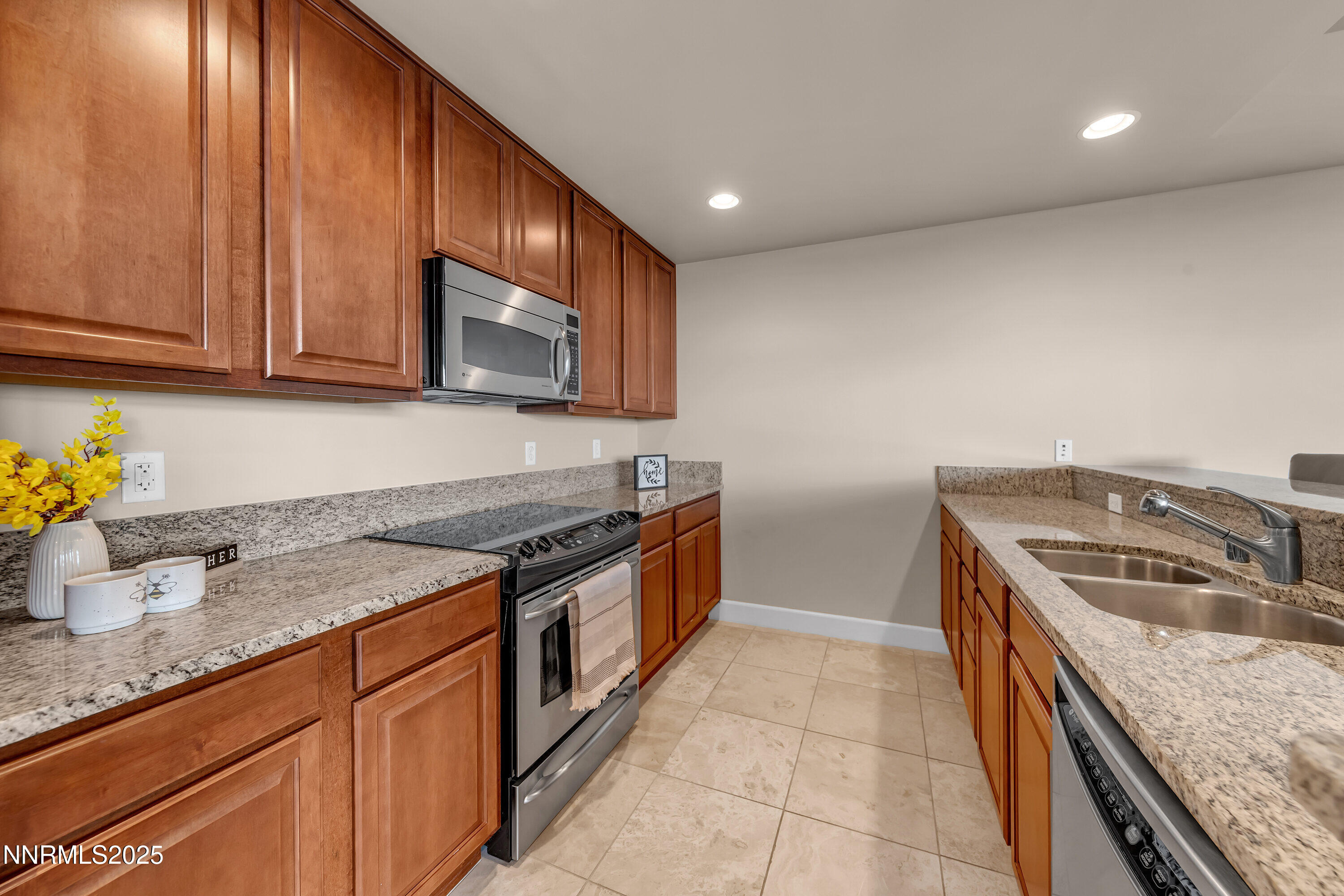 50 North Sierra Street, Unit 910 Reno, NV 89501 - Photo 5 of 20 a kitchen with stainless steel appliances granite countertop a sink a stove and a wooden cabinets