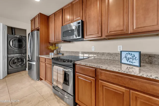 a kitchen with stainless steel appliances granite countertop a stove and a refrigerator