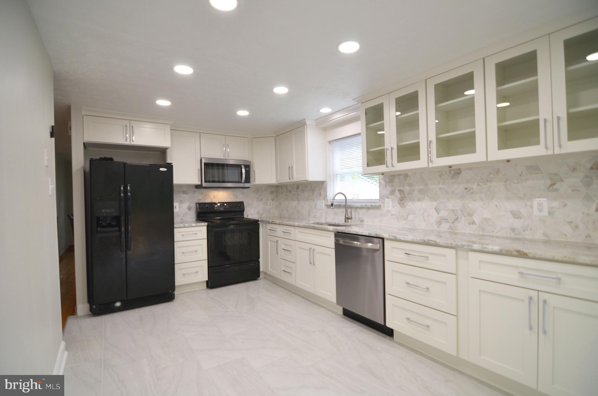 9251 Perfect Hour Columbia, MD 21045 - Photo 5 of 19 Glass front cabinets, recessed lighting,-all new!