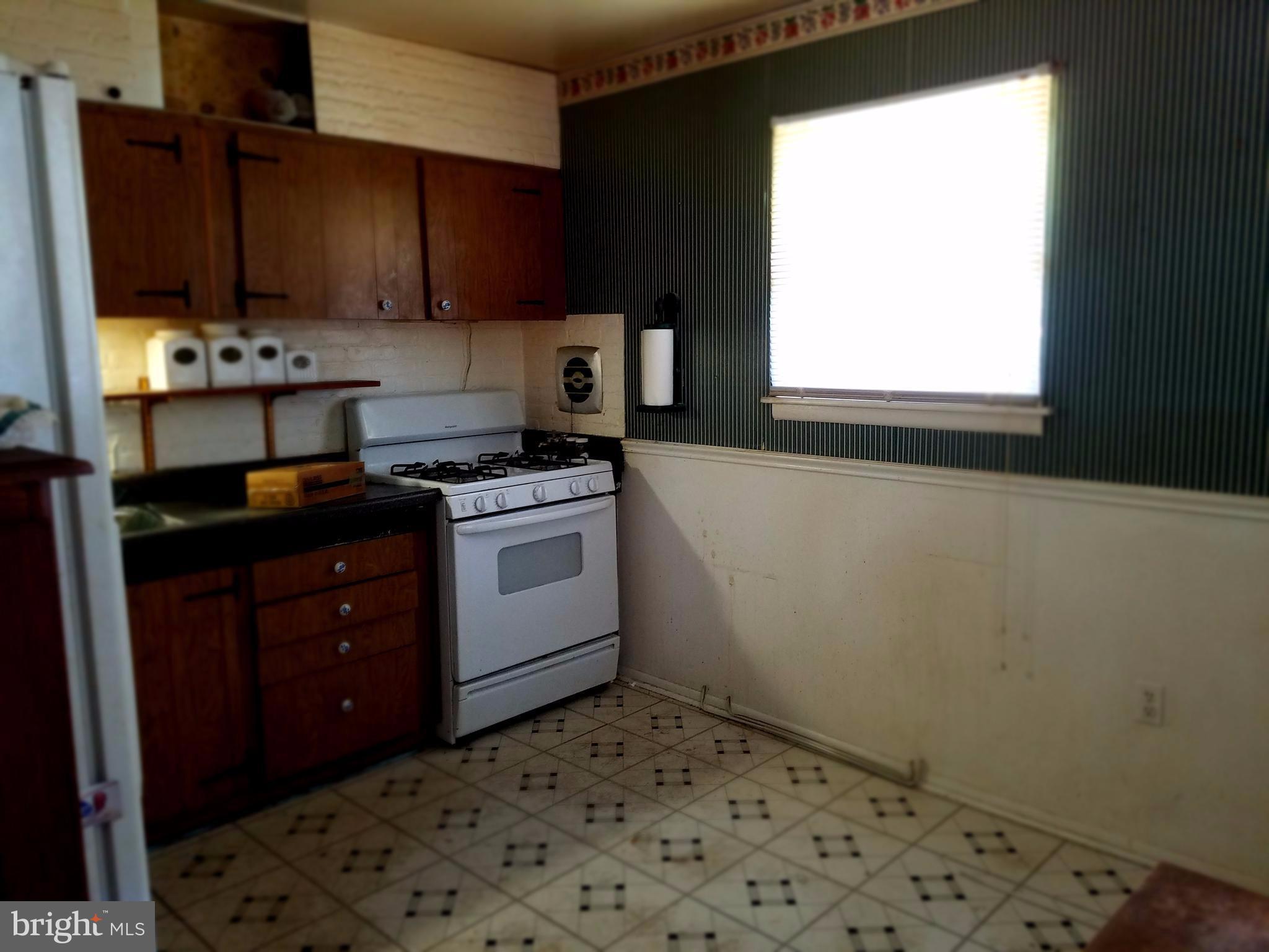500 Hammershire Road Owings Mills, MD 21117 - Photo 7 of 13 a kitchen with a stove a sink and a window