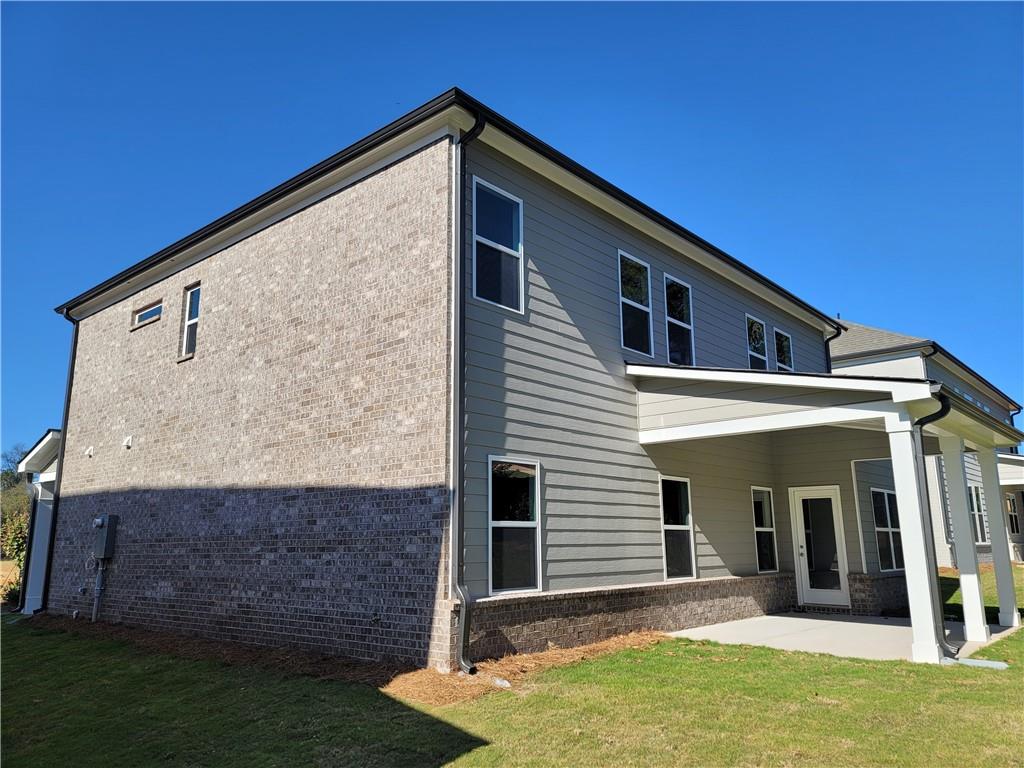 663 Secret Garden Lane Dacula, GA 30019 - Photo 2 of 27 a front view of a house with a yard