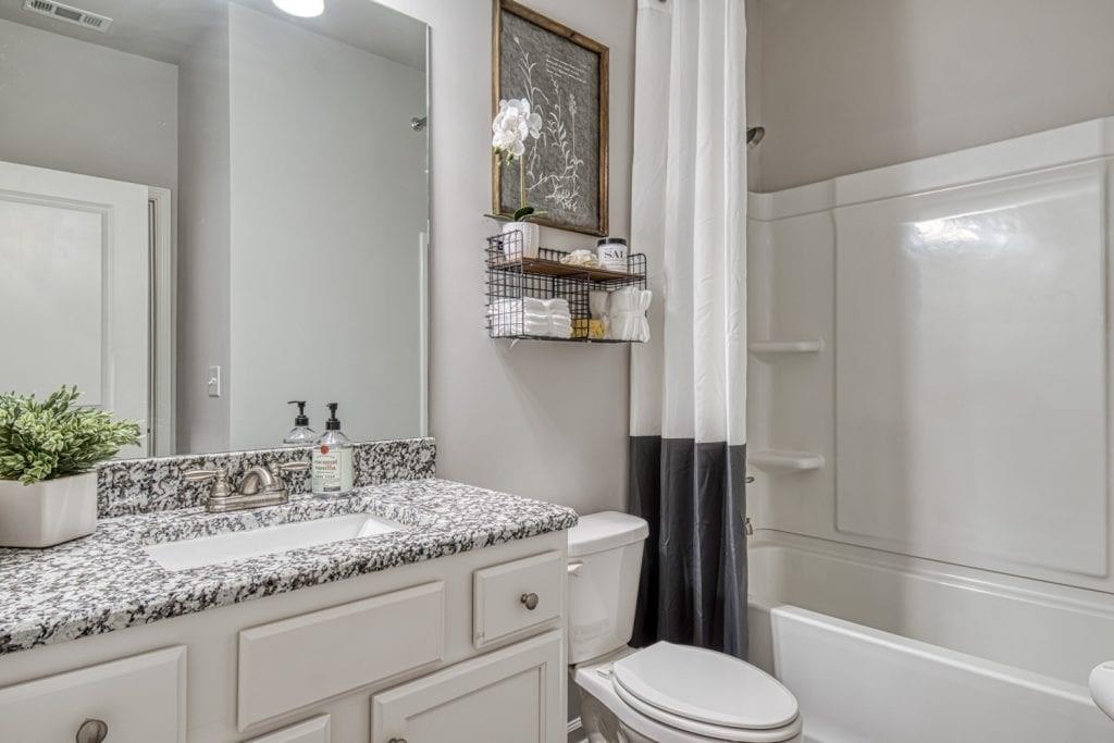 663 Secret Garden Lane Dacula, GA 30019 - Photo 10 of 27 a bathroom with a granite countertop sink toilet and shower