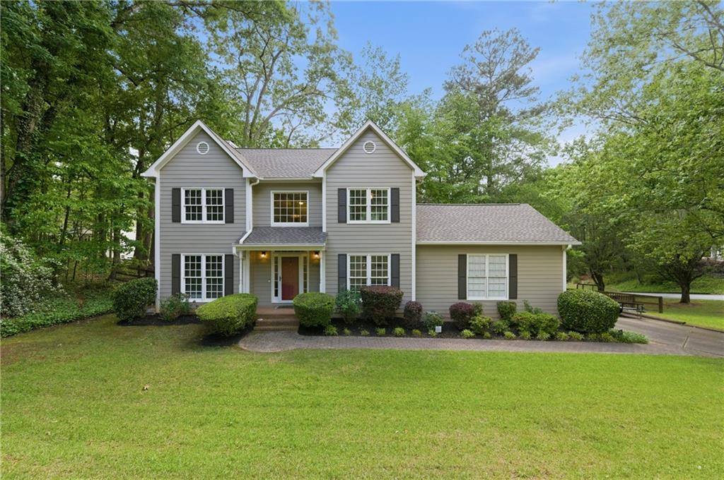 1925 Crescent Ridge Cumming, GA 30041 - Photo 2 of 36 a front view of house with yard and green space