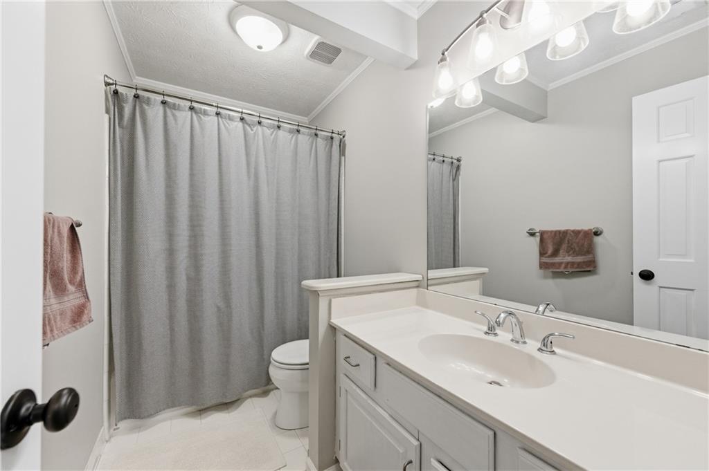 1925 Crescent Ridge Cumming, GA 30041 - Photo 28 of 36 a bathroom with a sink toilet double vanity and shower