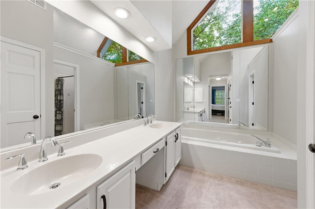 1925 Crescent Ridge Cumming, GA 30041 - Photo 30 of 36 a bathroom with a tub sink and mirror