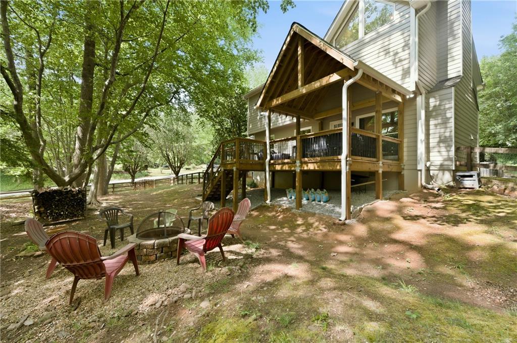 1925 Crescent Ridge Cumming, GA 30041 - Photo 34 of 36 a view of a house with backyard porch and sitting area