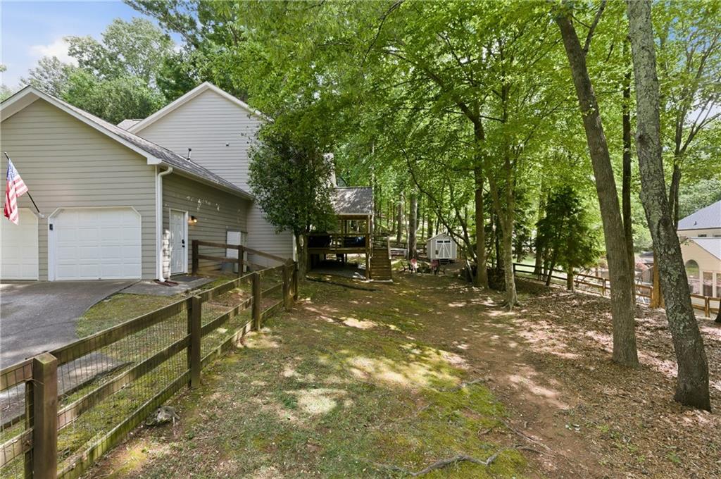 1925 Crescent Ridge Cumming, GA 30041 - Photo 36 of 36 a view of house with backyard and trees