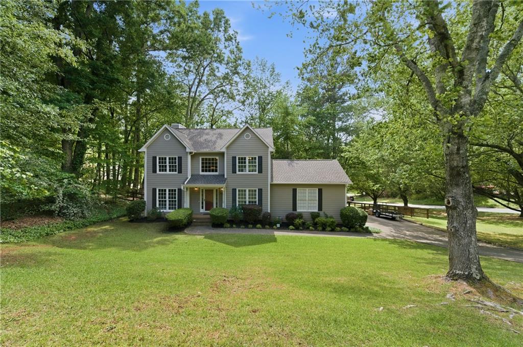 1925 Crescent Ridge Cumming, GA 30041 - Photo 4 of 36 a front view of a house with garden