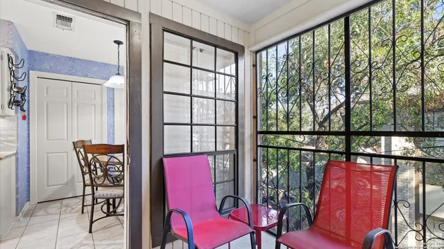 a balcony with table and chairs