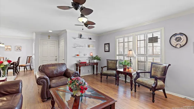 a living room with furniture a wooden floor and a window