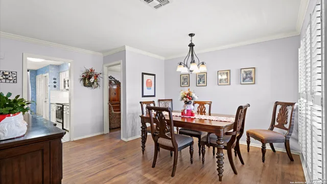 a view of a dining room with furniture wooden floor and a chandelier