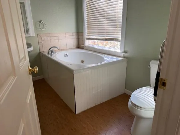 a bathroom with a bathtub and toilet