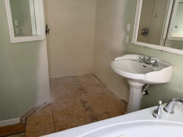 a bath room with a sink and a toilet