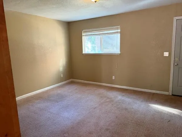 an empty room with a empty space and a window