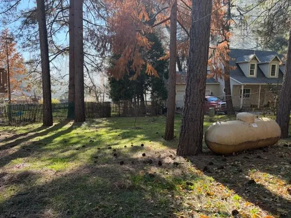 a view of a house with backyard and sitting area