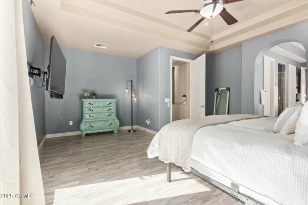 a bedroom with a bed and a chandelier