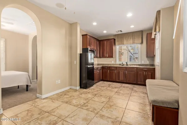 a kitchen with a sink a counter top space cabinets and stainless steel appliances