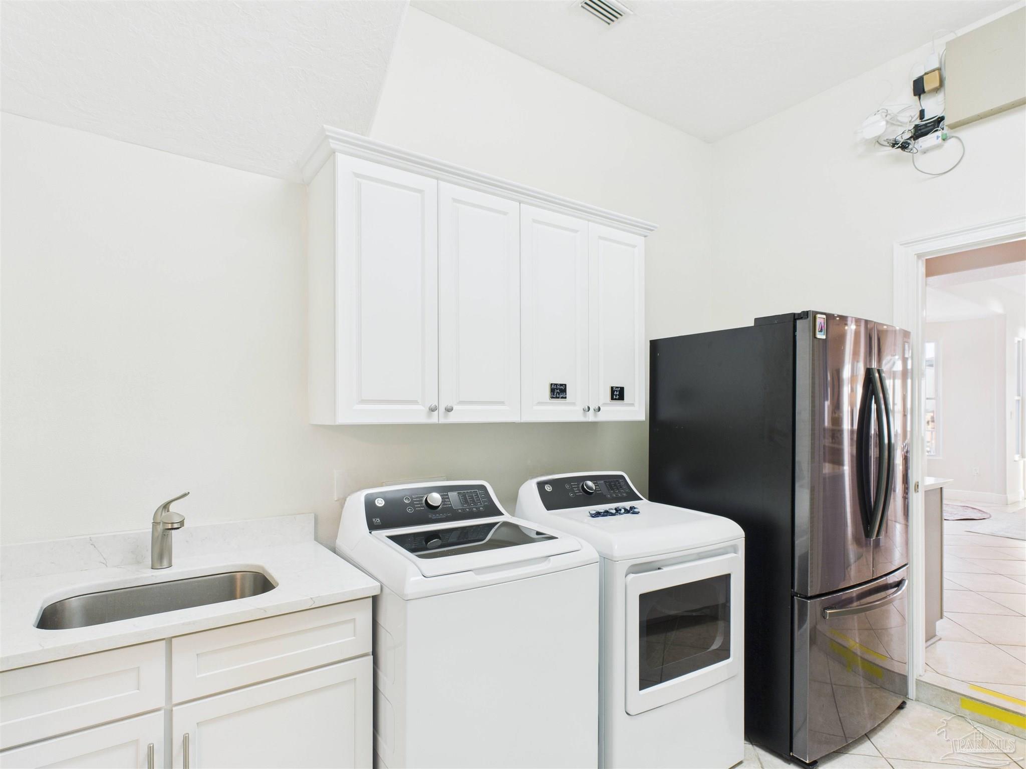 39 Mariners Lane Mary Esther, FL 32569 - Photo 31 of 70 a kitchen with a refrigerator sink and cabinets