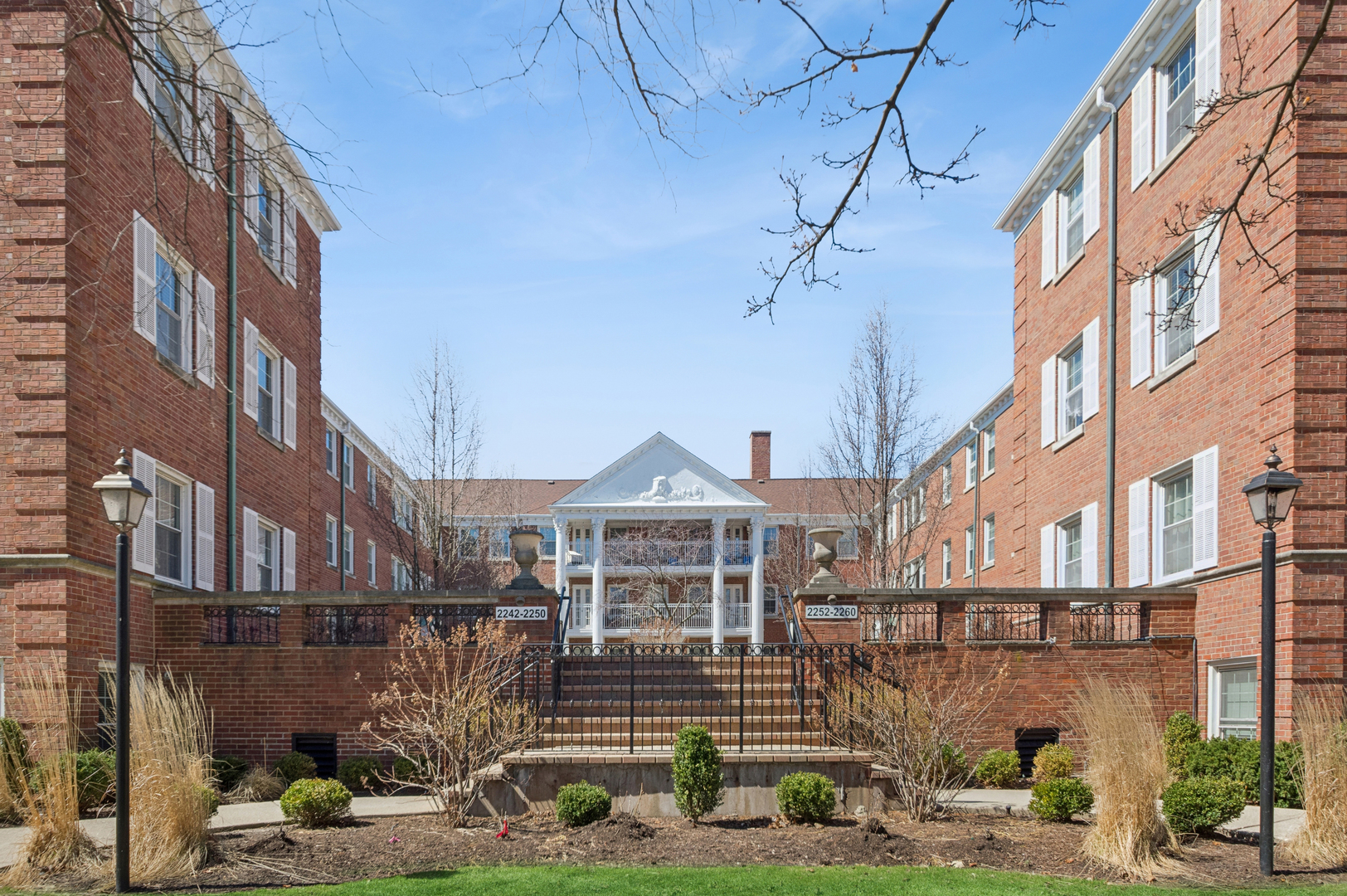 2242 Sherman Avenue, Unit G Evanston, IL 60201 - Photo 1 of 17 a front view of a residential apartment building with a yard