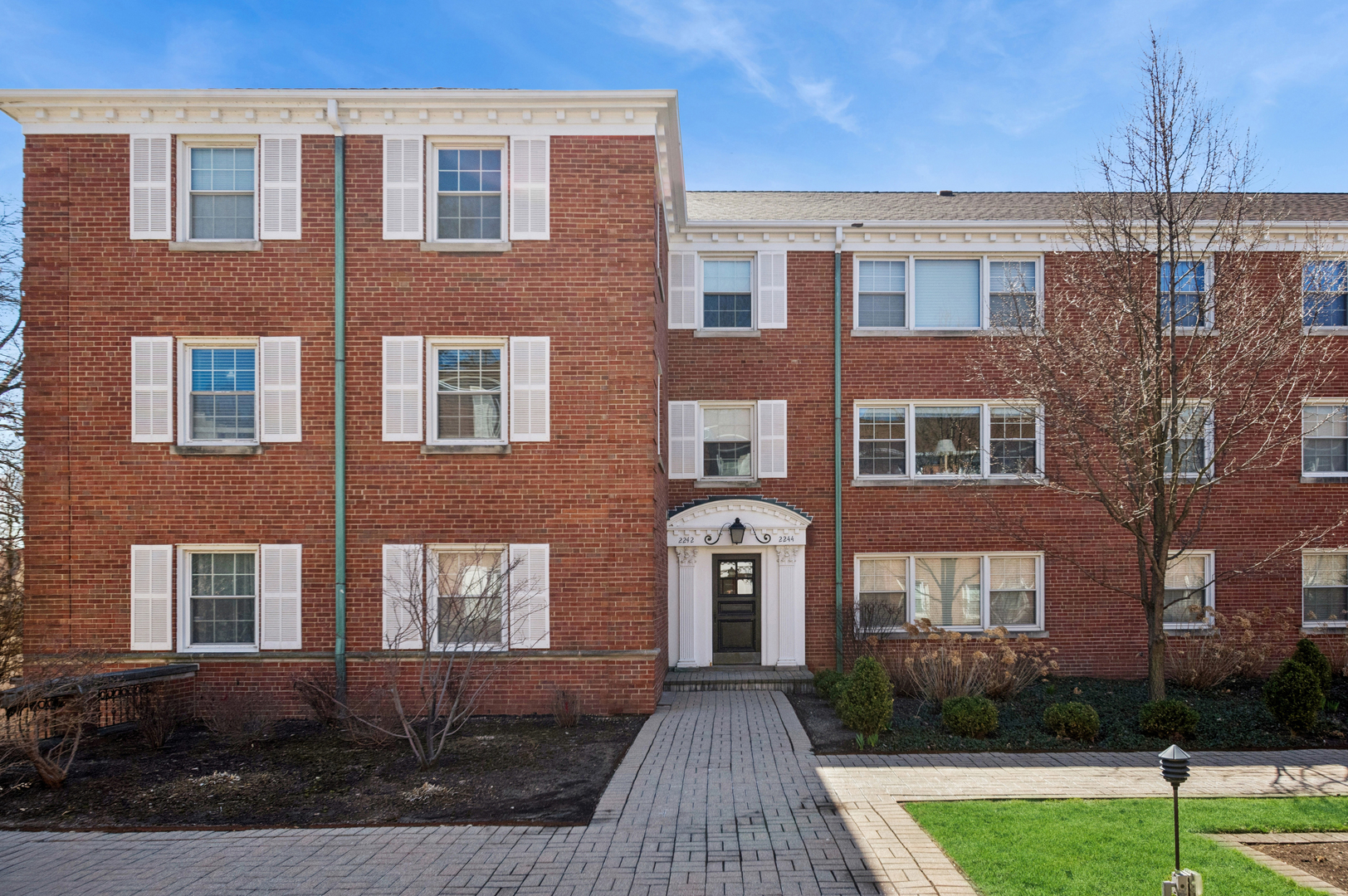 2242 Sherman Avenue, Unit G Evanston, IL 60201 - Photo 2 of 17 a front view of a house with yard