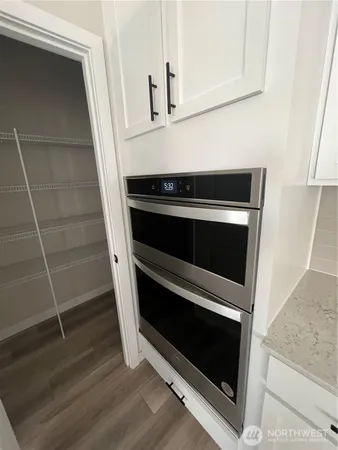 a stove top oven sitting inside of a kitchen