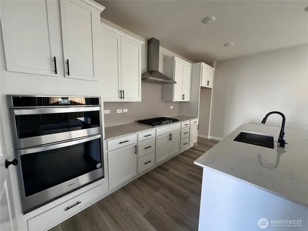 a kitchen with a refrigerator and a stove