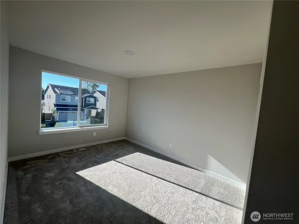 a view of a hallway with wooden floor and a door
